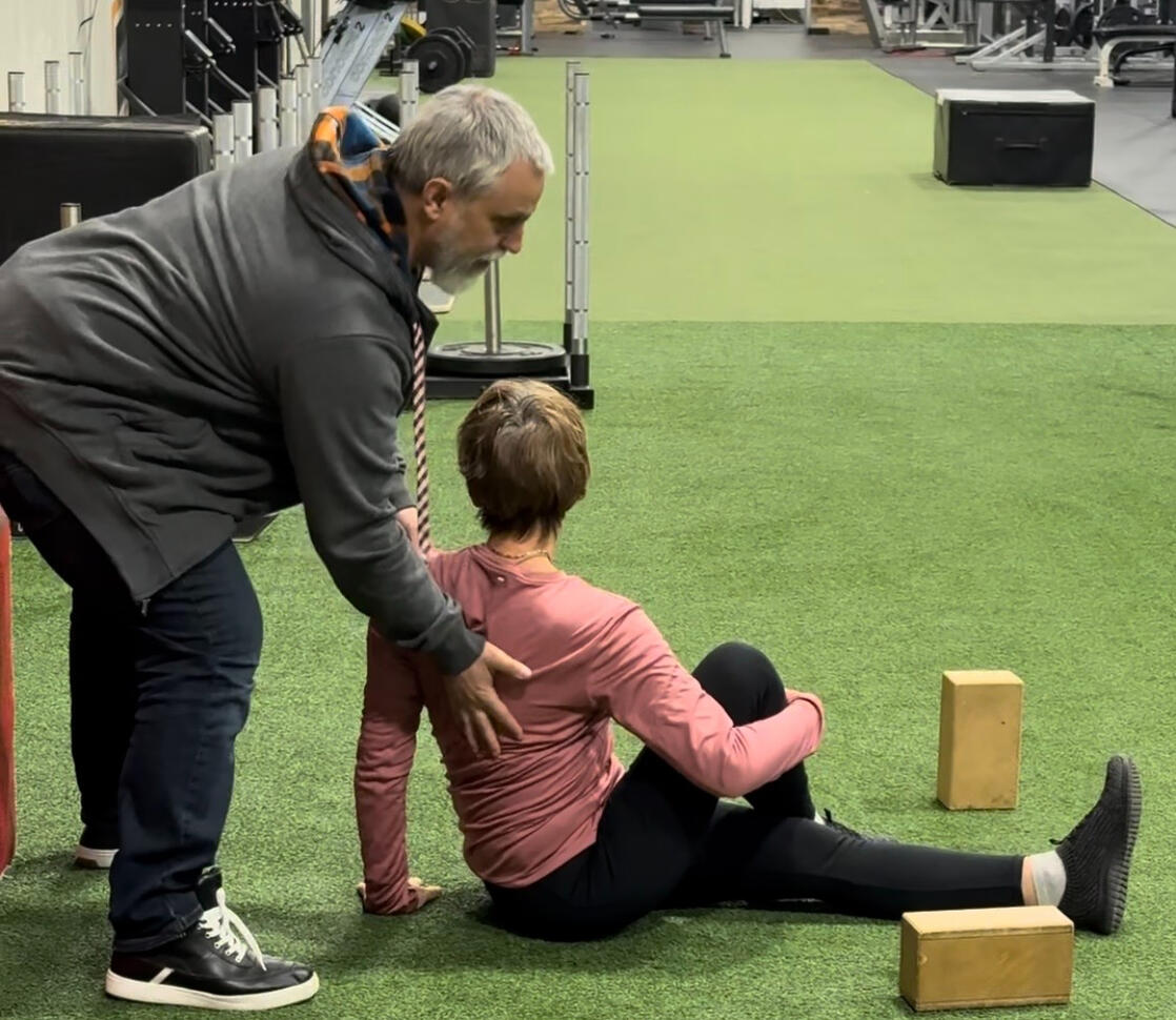 Oakville Personal Training Personal trainer assisting a client with movement assessment in Oakville